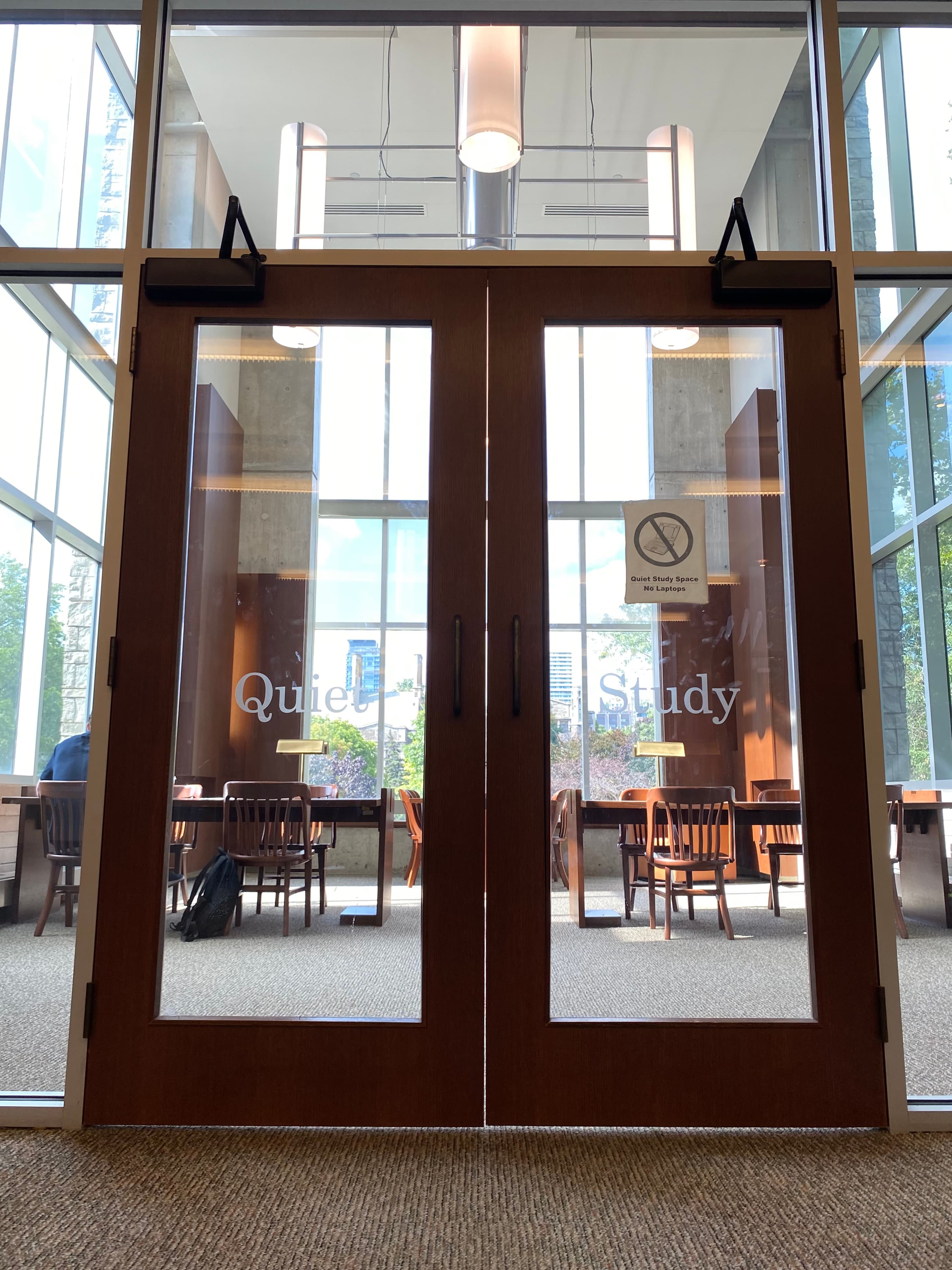 Glass doors to Silent Study Room, with student seated at a table.