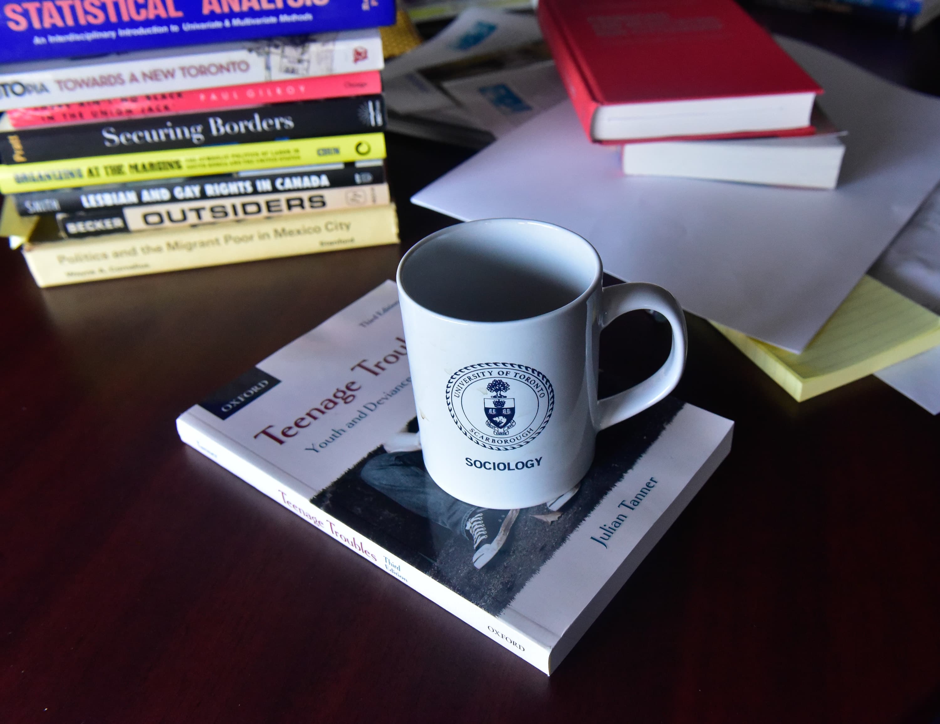 coffee mug on a stack of books