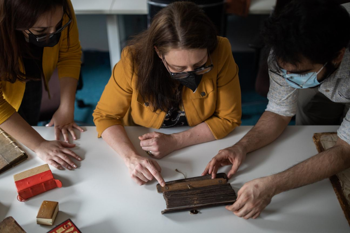 Gillespie and researchers analyze a palm leaf manuscript.