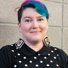 a woman with colourful hair and cassette tape shaped earrings