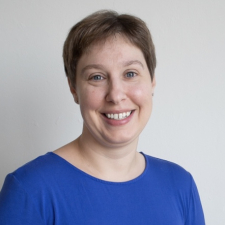 Profile photo of women with short hair, blue eyes, and blue shirt